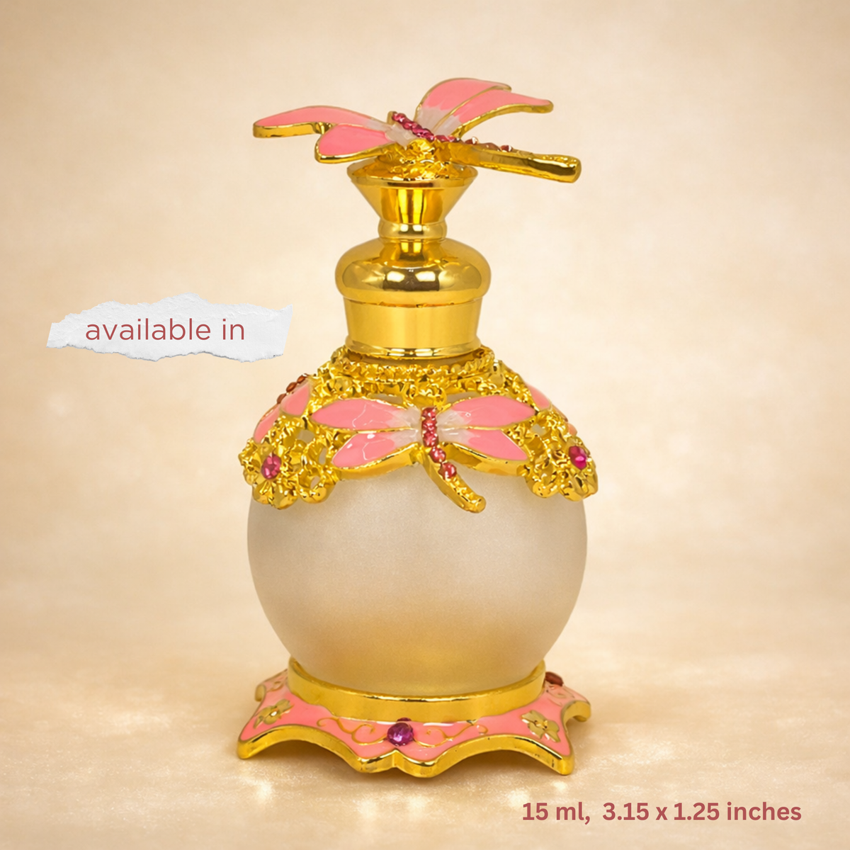 Decorative perfume bottle with gold and pink accents on a beige background
