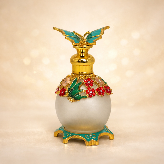 Decorative bottle with gold, green, and red accents on a beige background