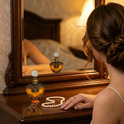 Woman's hand on vanity table with attar in brown heart bottle
